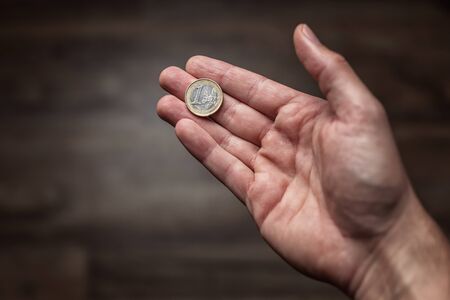 Euro coin held in the palm of the hand