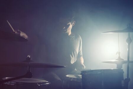 Drummer backlit by spotlightの写真素材