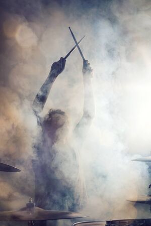 Drummer posing surrounded by fogの写真素材