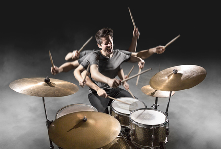 Drummer playing with many armsの写真素材