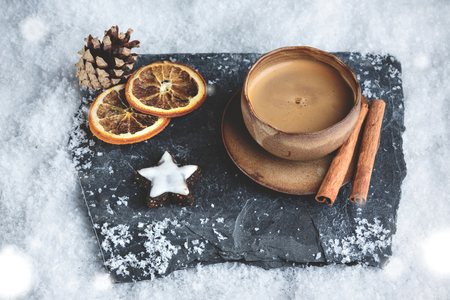 Espresso cup with winter decoration and snowの写真素材