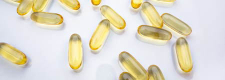 Transparent capsules scattered on a light backgroundの写真素材