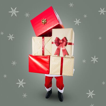 Santa Claus with a big stack of Christmas presentsの写真素材