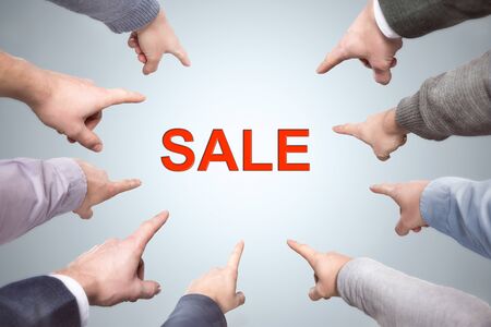 Many fingers point to the word SALEの写真素材