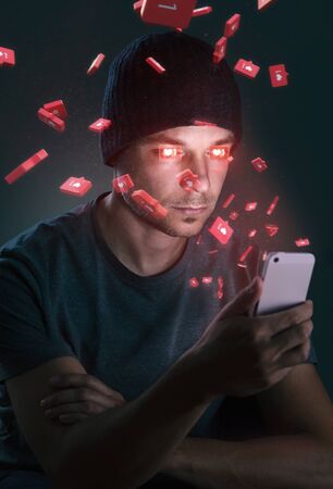Man addicted to social media is hypnotized by his smartphoneの写真素材