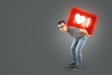Man carrying a large social media Like Symbol on his back