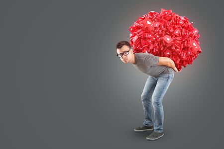 Man carrying a heap of social media Like Symbols on his backの写真素材
