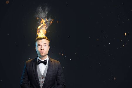 Funny portrait of a man with burning hairの写真素材