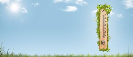 Spring time - thermometer overgrown with leaves and flowersの写真素材