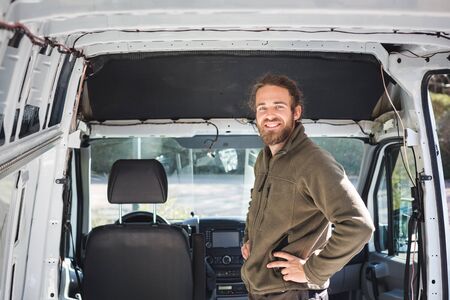 Smiling man inside his camper vanの写真素材