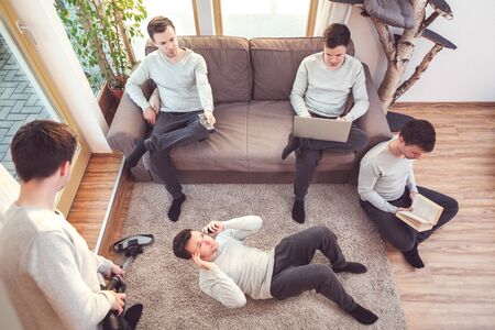 Same man engaged in various activities at homeの写真素材