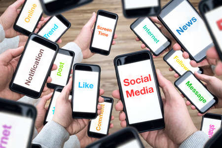 Social media terms on many smartphone screensの写真素材