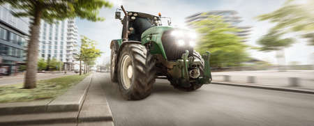 Tractor driving through a city