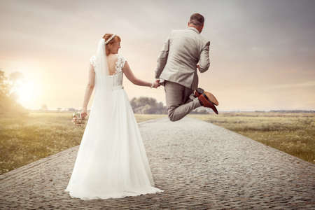 Bridal couple having fun on their wedding dayの写真素材
