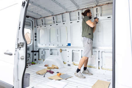 Man working on a camper van conversion