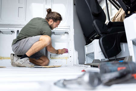 Man cleaning the inside of a vanの写真素材