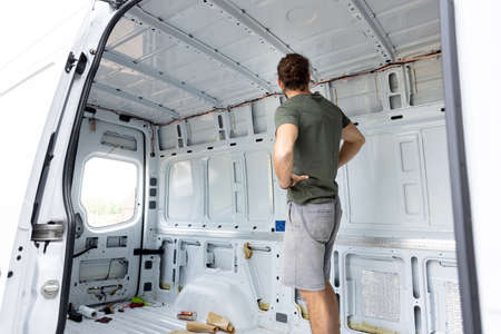 Man standing inside an empty vanの写真素材