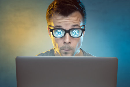 Man using the internet on a laptop computerの写真素材