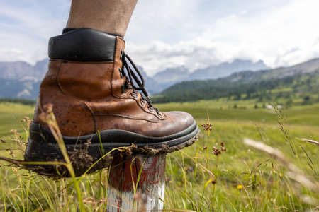 Hiking shoe in front of a mountain panoramaの写真素材