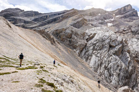 Hikers on their way down from a rough mountain topの写真素材