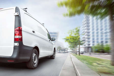 Fast delivery van driving in the cityの写真素材