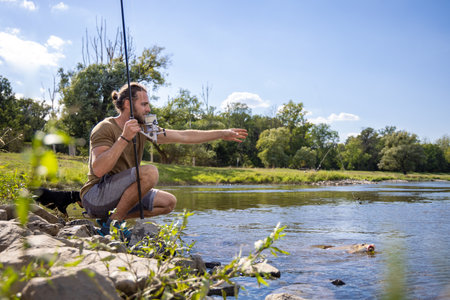 Hobby fisherman caught a fish in a riverの写真素材