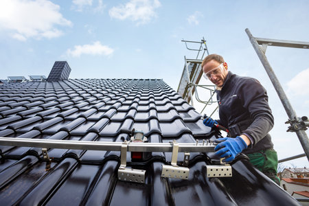 Craftsman installing the solar panel mounting system on a roofの写真素材