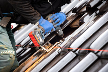 Fastening a bracket to the roof for a solar panel mounting systemの写真素材