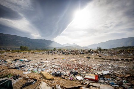 Polluted Landscape with Waste in Front of a Mountain Background - shot in Albaniaの写真素材