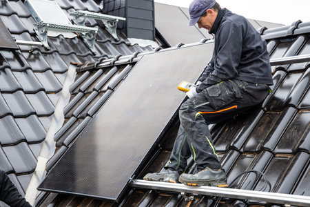 Technician Using a Multimeter for Solar Panel Installationの写真素材