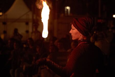 BUCHAREST, ROMANIA - SEPTEMBER 13: Lara Castiglioni plays with fire torch during B-FIT in the Street, International Street Theater Festival on September 13, 2012 in Bucharest, Romania.のeditorial素材