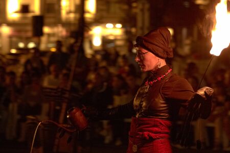 BUCHAREST, ROMANIA - SEPTEMBER 13: Lara Castiglioni plays with fire torch during B-FIT in the Street, International Street Theater Festival on September 13, 2012 in Bucharest, Romania.のeditorial素材