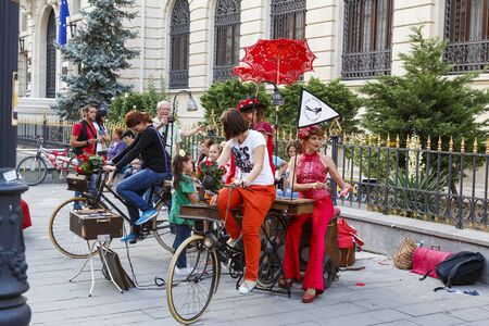 BUCHAREST, ROMANIA - SEPTEMBER 13: Unidentified lady cycles the stationary bike to power the sewing machine during B-FIT in the Street Festival on September 13, 2012 in Bucharest, Romania.のeditorial素材