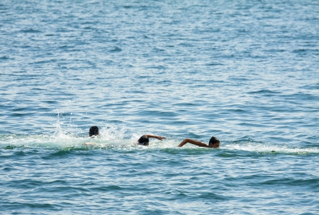 CONSTANTA, ROMANIA - AUGUST 3: Playful kids swim in the waters of Black Sea on August 3, 2011 in Constanta port, Romania. Constanta is the largest port on the Black Sea and the 18th largest in Europe.のeditorial素材