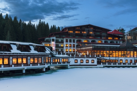 POIANA BRASOV, ROMANIA - DECEMBER 25: Aurelius Hotel at twilight on December 25, 2013 in Poiana Brasov, Romania. It is located by the Miorita lake in Poiana Brasov, most famous ski resort in Romania.のeditorial素材