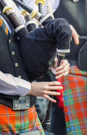 Unidentified young bagpiper dressed in traditional Irish uniform performs at the 2nd St  Patrick s Day Parade on March 16, 2014 in Bucharest, Romania  Detail, closeup のeditorial素材