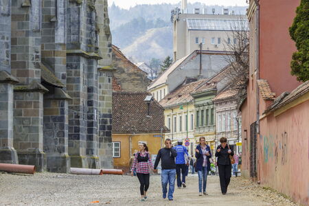 BRASOV, ROMANIA - MARCH 23: Unidentified people walk past the Black Church on March 23, 2014 in...