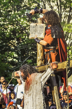 BUCHAREST, ROMANIA - MAY 3: Unidentified men playing Jesus and Roman soldier reenact the crucifixion of Jesus Christ during the Way of the Cross on May 3, 2013 in Bucharest, Romania.のeditorial素材
