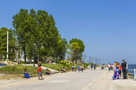 CONSTANTA, ROMANIA - MAY 25: Unidentified tourists stroll and enjoy the sights on Casino sea wall on May 25, 2014 in Constanta, the oldest living city in Romania, founded around 600 BC.のeditorial素材
