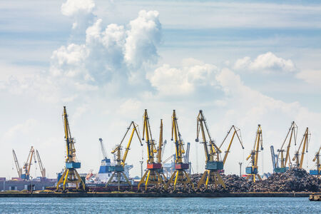 CONSTANTA, ROMANIA - MAY 27, 2014: Industrial port quay with heavy load dockside cranes recycling iron and steel waste in Constanta port, the largest on the Black Sea and the 18th largest in Europe.のeditorial素材