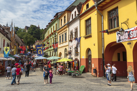SIGHISOARA, ROMANIA - JULY 26, 2014: Unidentified people wander the old streets of the medieval citadel of Sighisoara, a UNESCO World Heritage Site and birth place of Vlad Tepes (Dracula) in 1431.のeditorial素材