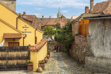SIGHISOARA, ROMANIA - JULY 26, 2014: Unidentified tourists stroll the old streets of the medieval citadel of Sighisoara, a UNESCO World Heritage Site and birth place of Vlad Tepes (Dracula) in 1431.のeditorial素材