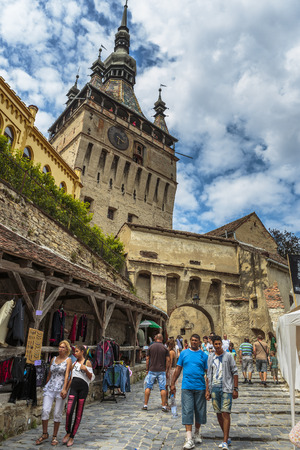 SIGHISOARA, ROMANIA - JULY 26, 2014: Unidentified tourists visit the medieval citadel of Sighisoara, Romania, one of the few still inhabited citadels in Europe and a UNESCO World Heritage Site.のeditorial素材
