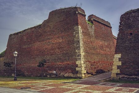 Ruins of brick fortification walls and cobblestone alleys of the medieval strategic fortress of Alba Iulia, Romania.の写真素材