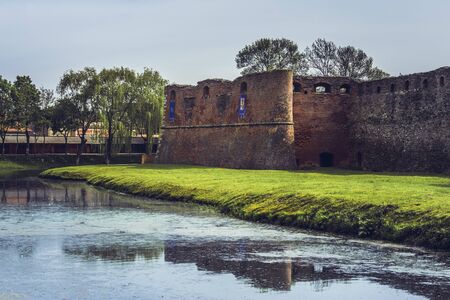 FAGARAS, ROMANIA - MAY 6, 2015: The fortification walls of the Fagaras fortress, one of the most robust defensive structure in Romania, built around 1310, surrounded by a wide moat filled with water.のeditorial素材