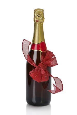 Anniversary champagne bottle with red knotted bow isolated on white.の写真素材