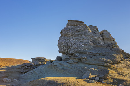 The Sphinx (Sfinxul) natural rock formation over clear blue sky in Bucegi Mountains, Romania.の写真素材