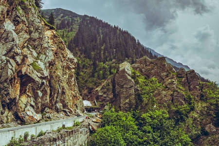 Mountain scenery with Transfagarasan road winding along high rocky cliffs at high altitude in...