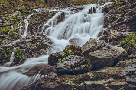 Majestic mountain stream waterfall nearby the famous Transfagarasan road in Fagaras mountains, Romania. Long exposure motion blur.の写真素材