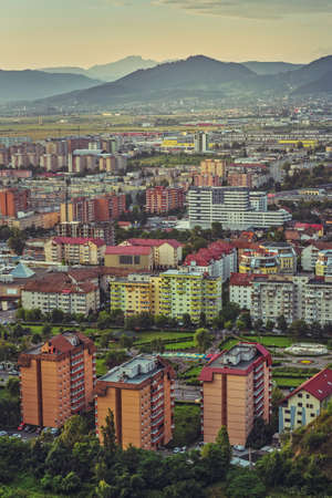 Early morning aerial cityscape of residential districts and suburbs of the Brasov city, the 7th largest city and most visited in Romania.の写真素材